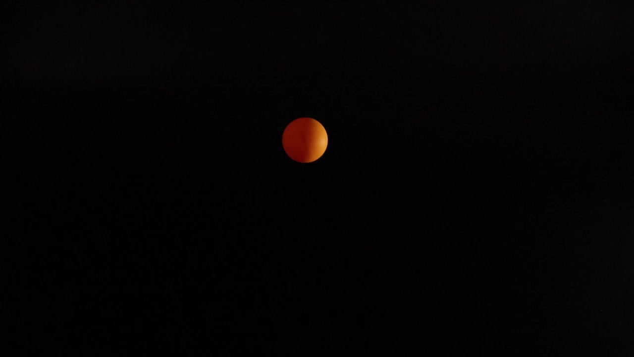Orange ball bouncing in a dark environment