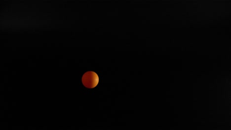 orange ball bouncing in a dark environment