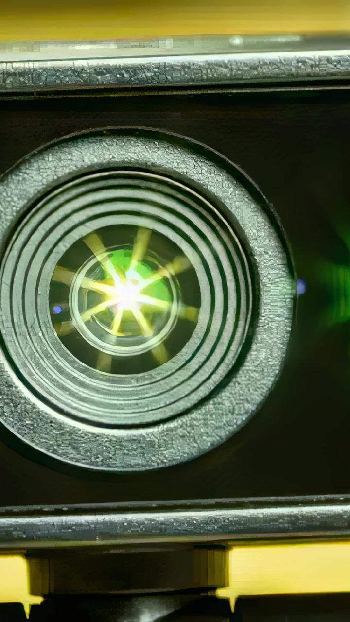 Vertical video: Entering off-frame point light creating starburst on mounted camera lens at monitor