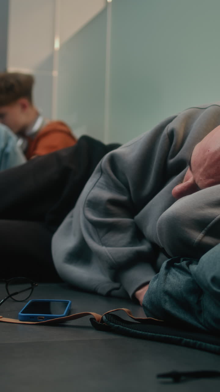 Teenagers Sleeping in a Hallway