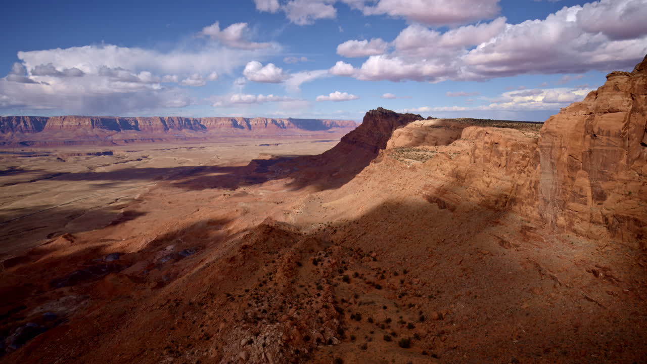 Sweeping aerial footage moving along the jagged mountain edge, revealing the sharp vertical descent near Antelope Pass Vista.