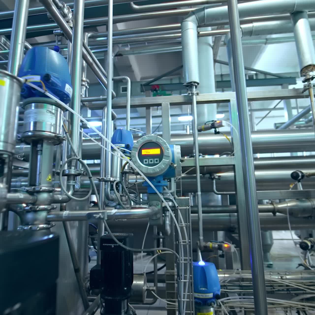 Inside the milk products factory. Complicated system of pipelines, cisterns and tubes and sensors at the dairy manufacturing plant