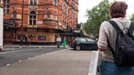 person walking through a busy london street