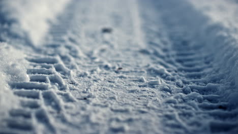 wheel mark snow surface at frosty winter day closeup. roadway covered white snow