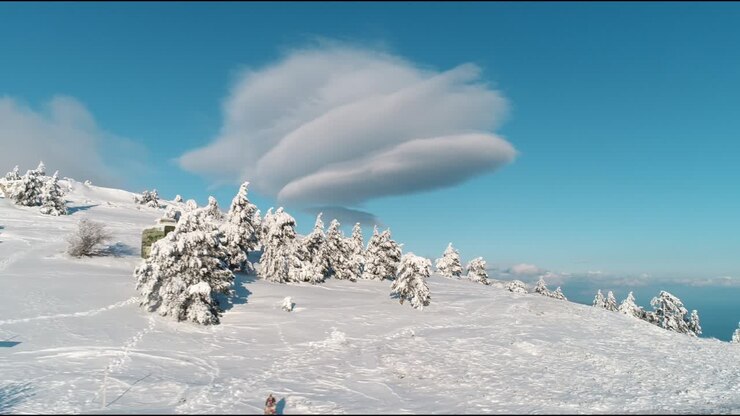 Snowy Mountain Peaks with Unusual Clouds