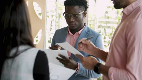 cheerful young people writing on paper