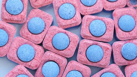 colorful capsules for washing dishes a pile of several dishwashing capsules rotates