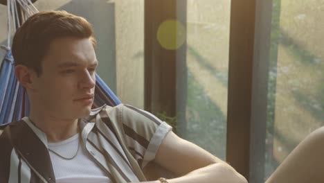 Close-Up-Of-Man-Resting-In-A-Hammock-At-Home