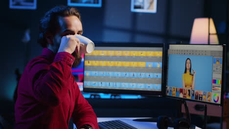 Portrait-of-happy-photo-editor-color-correcting-photographs-in-creative-studio-while-enjoying-coffee