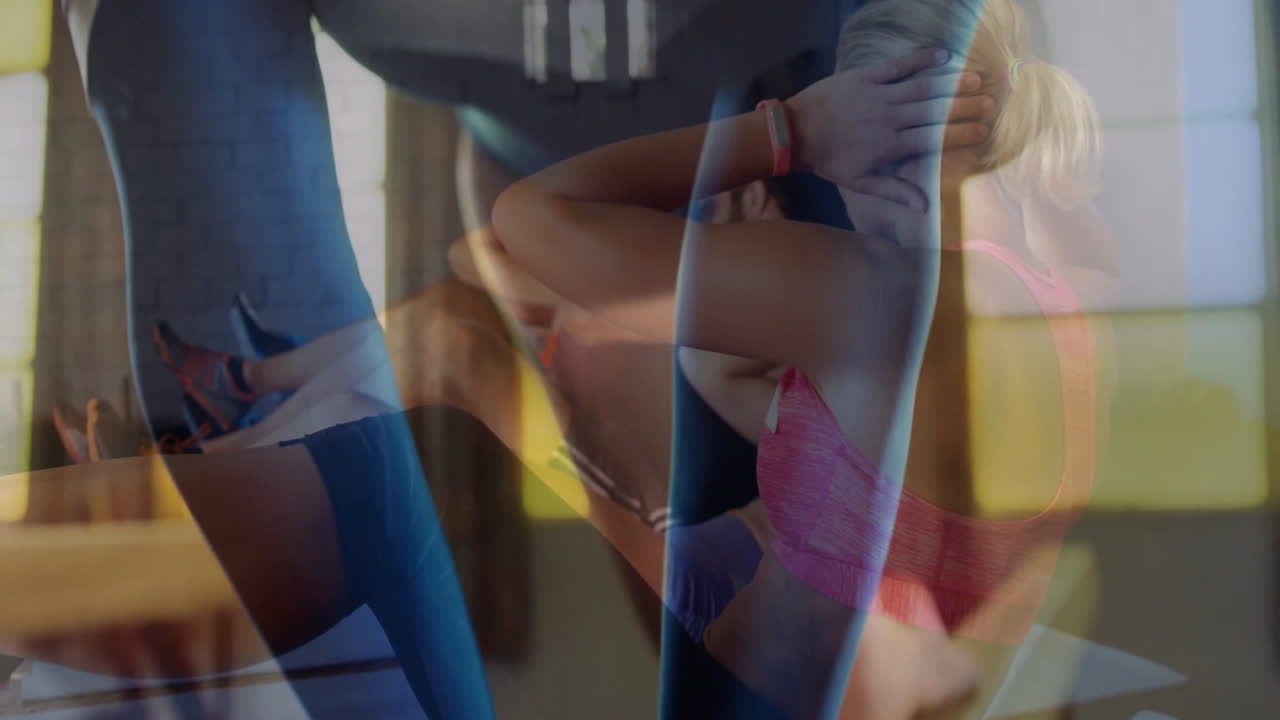 Workout duo performing crunches on mats in fitness gym showing layered overlay with smartwatch icon