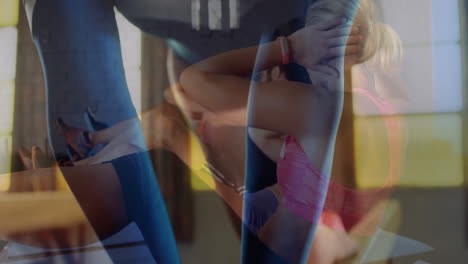 workout duo performing crunches on mats in fitness gym showing layered overlay with smartwatch icon