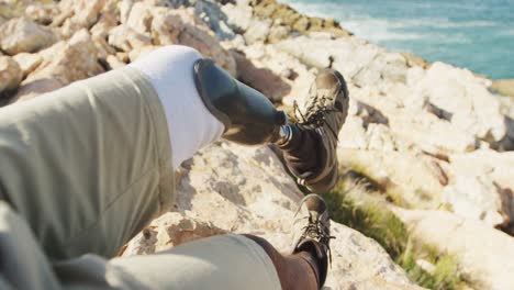 sporty mixed race man with prosthetic leg enjoy his hike