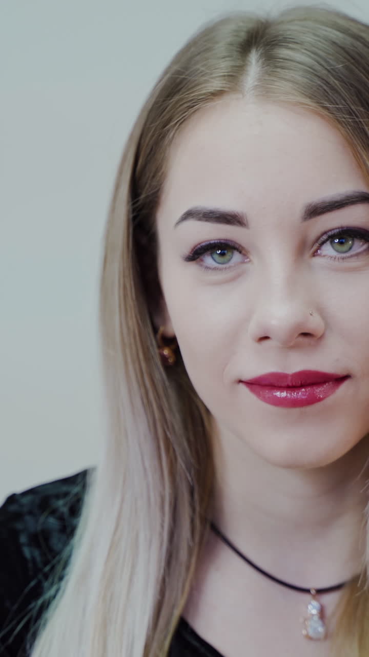 Beautiful smiling woman. Beautiful face of young caucasian woman with perfect make up. Vertical video