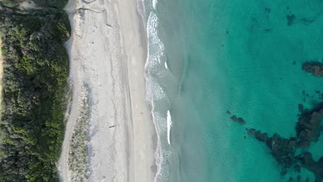 cinematic topdown drone shot from beach and waves