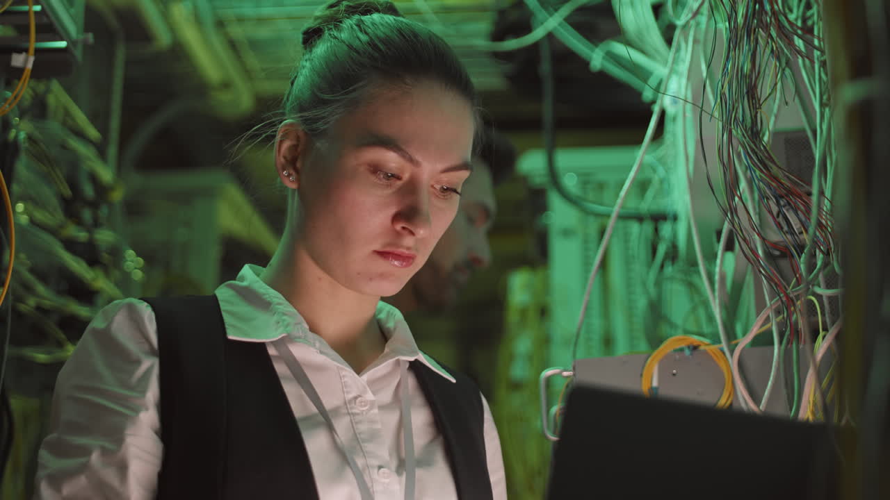 Woman working in a data center server room