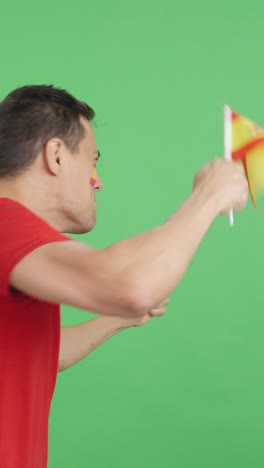Rear view of a man waving a spanish pennant