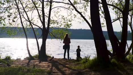 mother and son by the lake at sunset