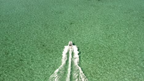 Motorboat-Sailing-in-Turquoise-Tropical-Sea-Water-Birdseye-Tracking-Drone-Aerial-View