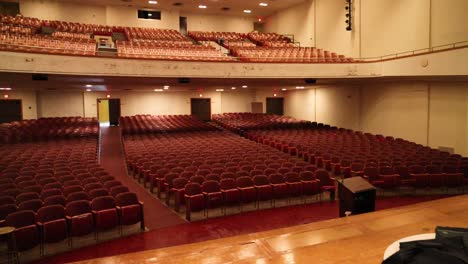 old high school auditorium with gimbal video walking onto stage.