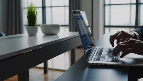 hands using a laptop for online transactions or work