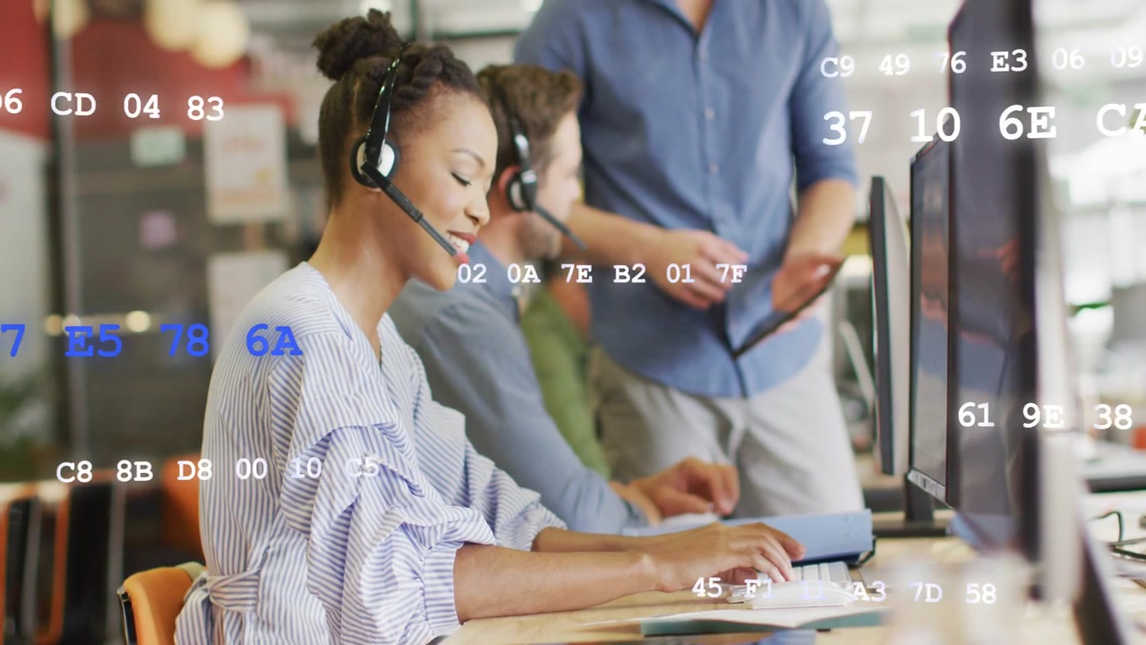 Agent typing, speaking on headset at support lead coming pointing tablet for help hex over screens