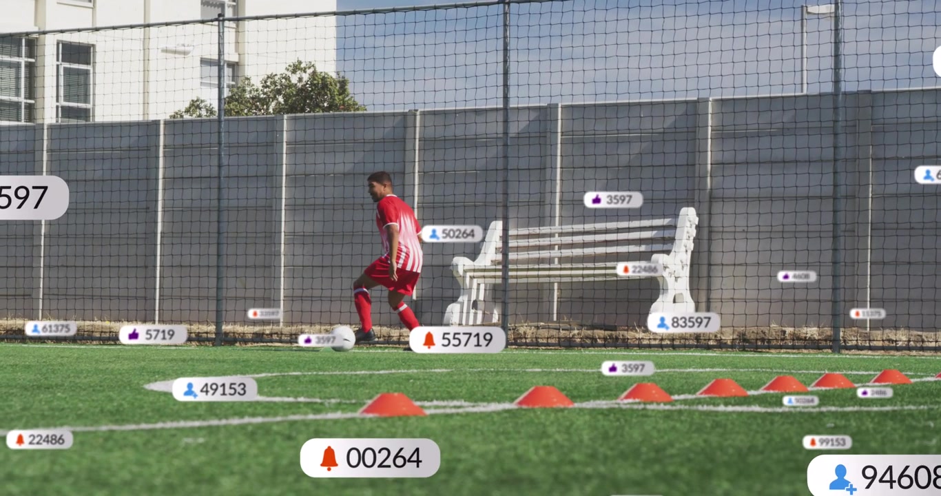 Animation of media icons over male soccer player with ball