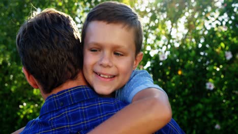 Father-and-son-embracing-each-other-in-park