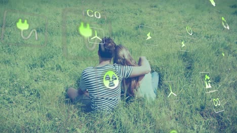 animación de iconos de la ecología sobre una pareja caucásica abrazándose