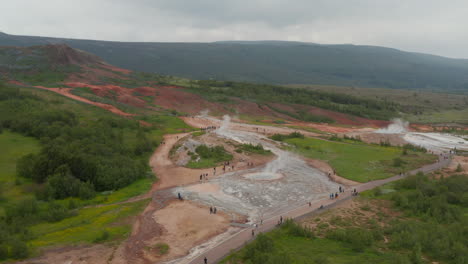 Drone-view-of-geothermic-geysyr-valley-in-Iceland.-Steaming-geothermic-active-icelandic-field-of-geyser.-Tourism-destination.-Amazing-in-nature.-Geyser-valley