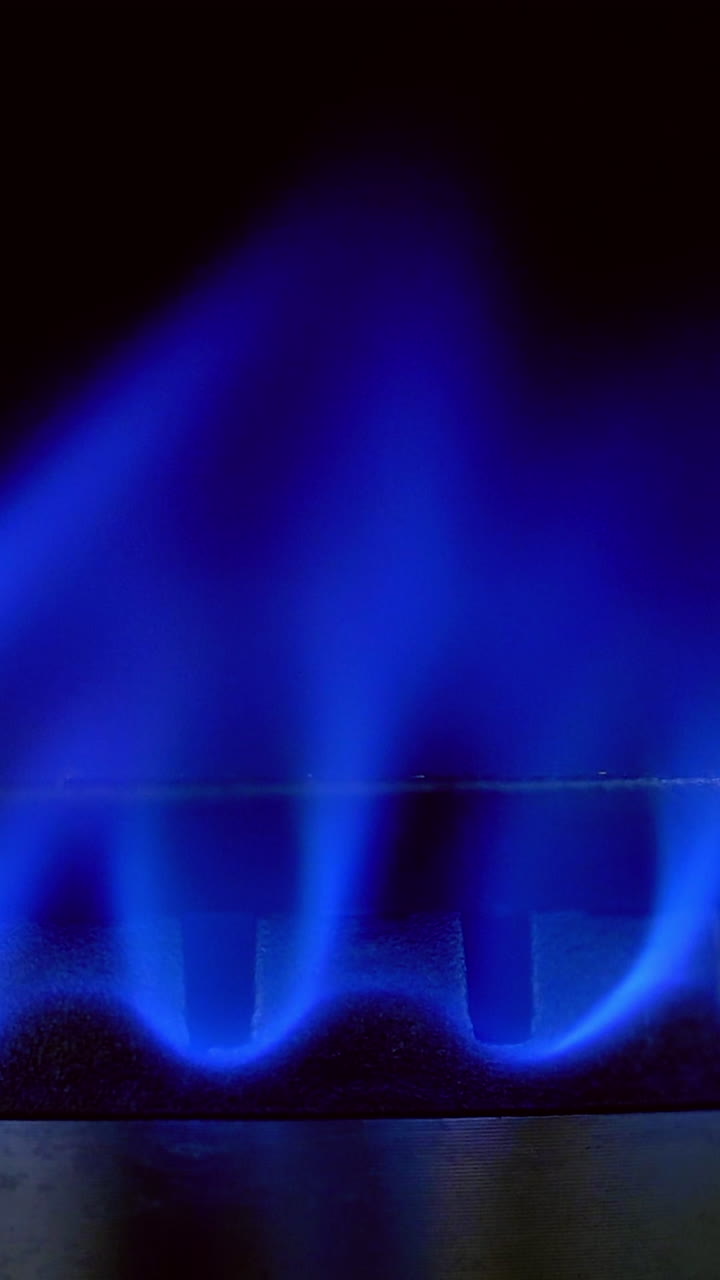 Gas Stove Burner Blue Flame. Kitchen gas cooker with burning fire propane gas