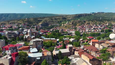 Aerial:-old-town-Tbilisi-city-centre-in-Georgia,-Swifts-flying-towards-camera