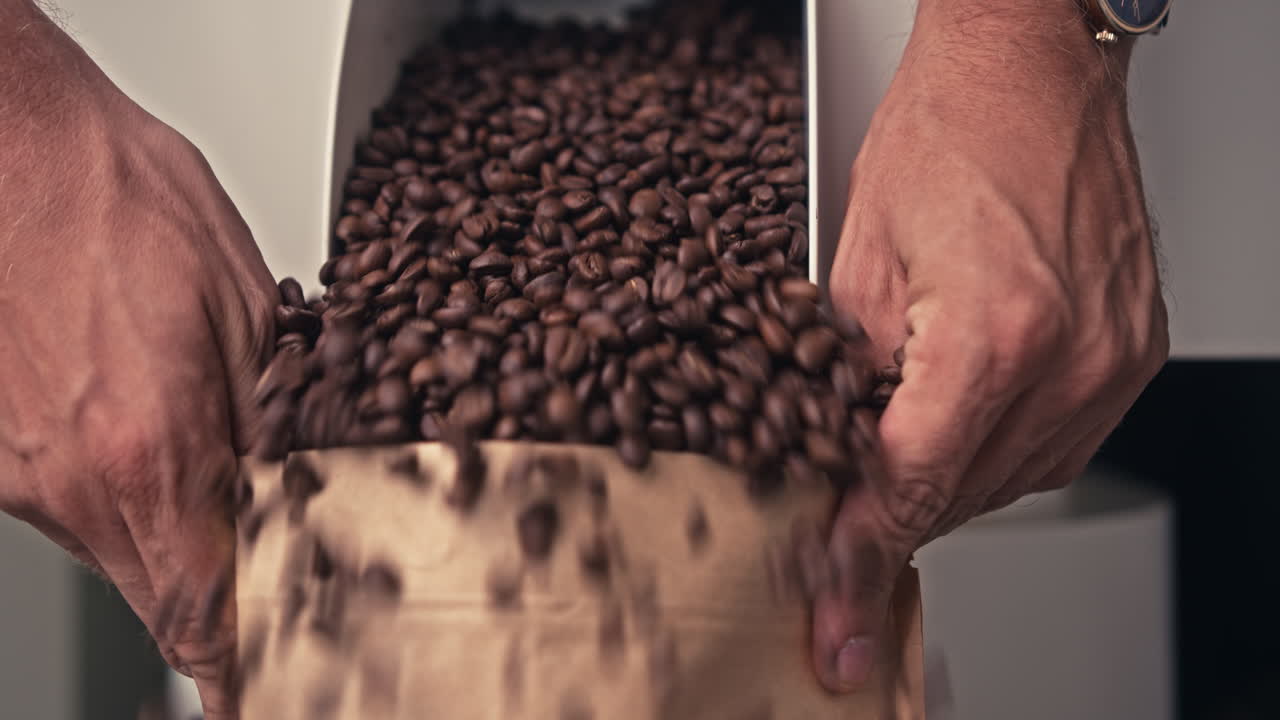 Pouring Roasted Coffee Beans into a Paper Bag