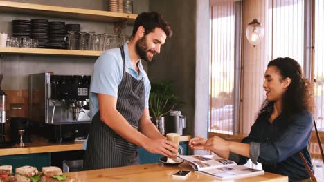 Lächelnde-Frau,-Die-Am-Tisch-Einen-Kaffee-Trinkt