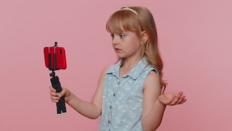 child girl kid blogger taking selfie on smartphone communicating video call online with subscribers