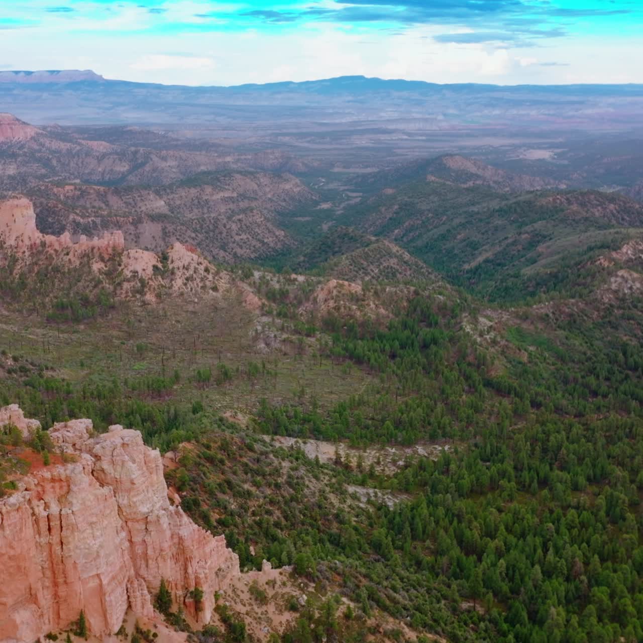 Panning view of the beautiful rocks in Utah, USA. Pine tree forest covering the landscape at the backdrop of blue sky