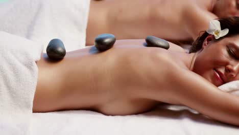 Relaxed-couple-having-hot-stone-massage