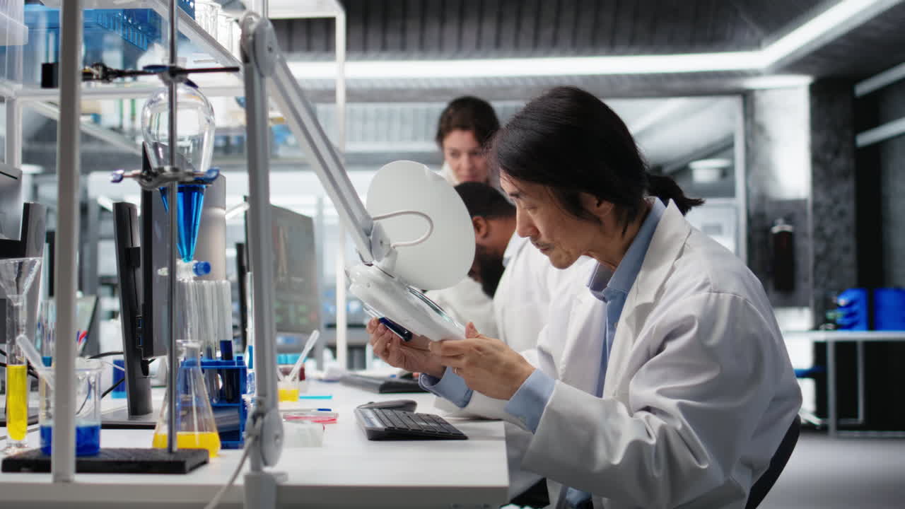 Vertical video Lab professional examines test tube sample under controlled lighting