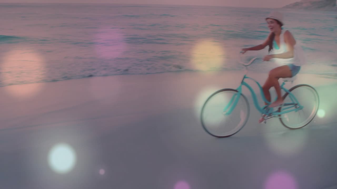 After flares drifting, rider pedaling turquoise cruiser with straw sunhat on beach for travel ads
