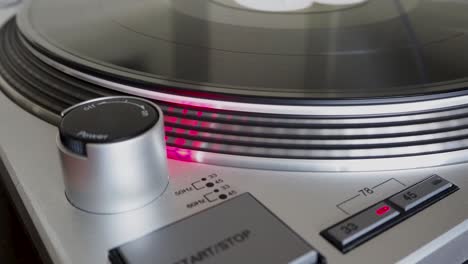 close up, modern turntable with rotating vinyl record, dj gear, equipment