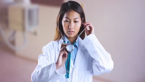 animation of asian female doctor using stethoscope over blue ribbon