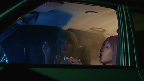two women in a car at night