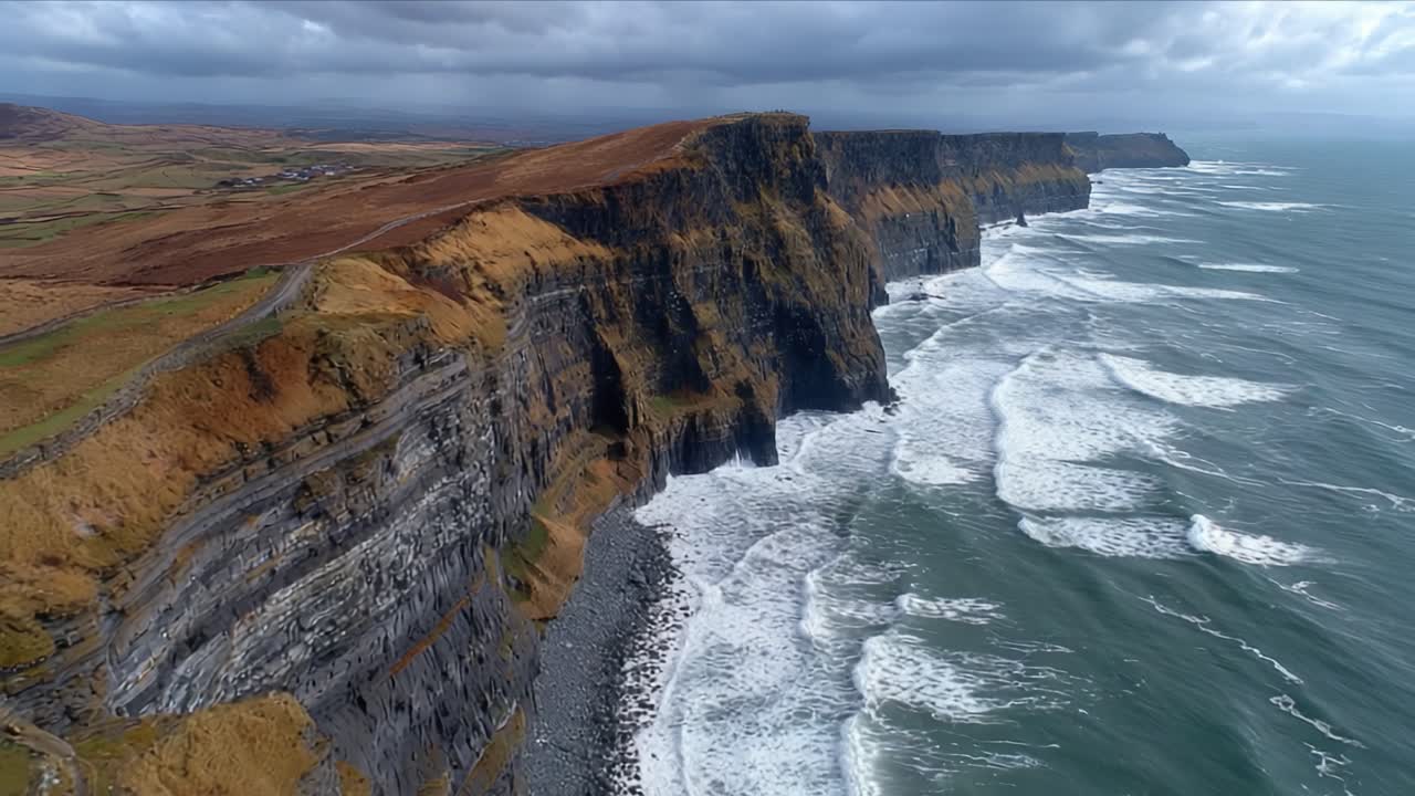 Aerial View of Majestic Cliffs Overlooking Turbulent Ocean Waves, Capturing the Dramatic Landscape of Coastal Nature in All Its Glory
