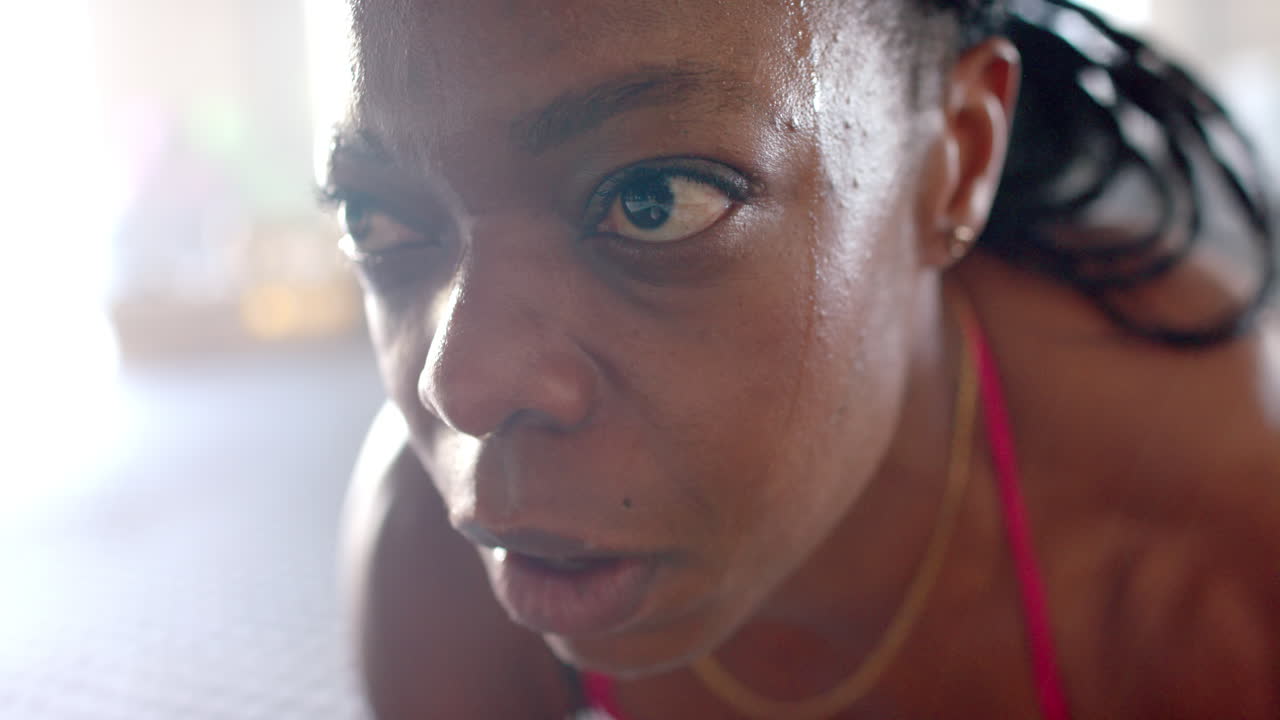 Close-up of woman exercising intensely in gym, showing determination and focus