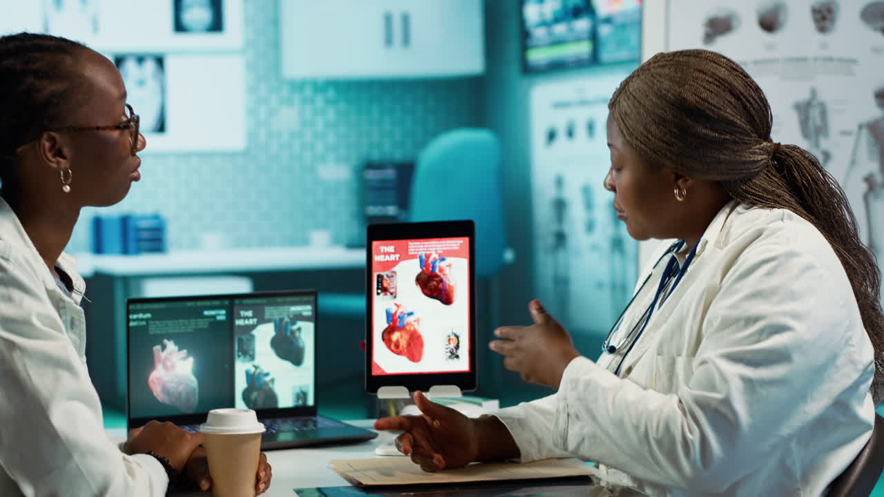 Medical office scene of a doctor and patient evaluating cardiology test results