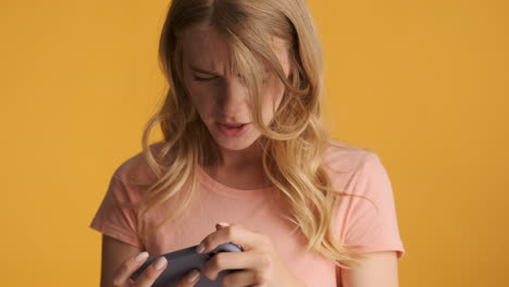 Caucasian-woman-playing-video-games-on-smartphone.