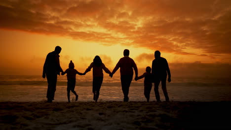 family enjoying a sunset walk on the beach