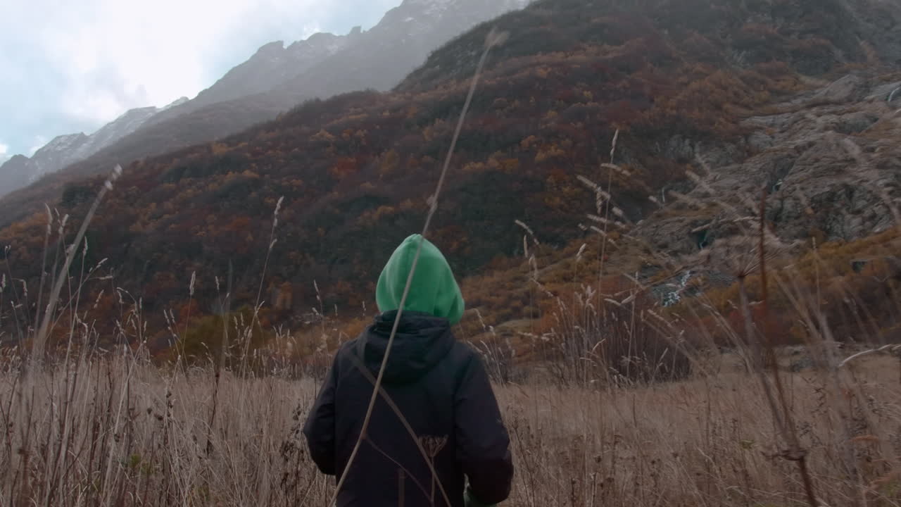 Child looking at majestic mountains in autumn