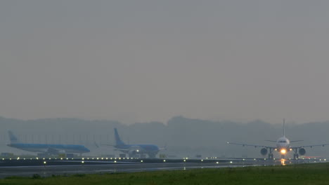 airplanes on runway in misty morning