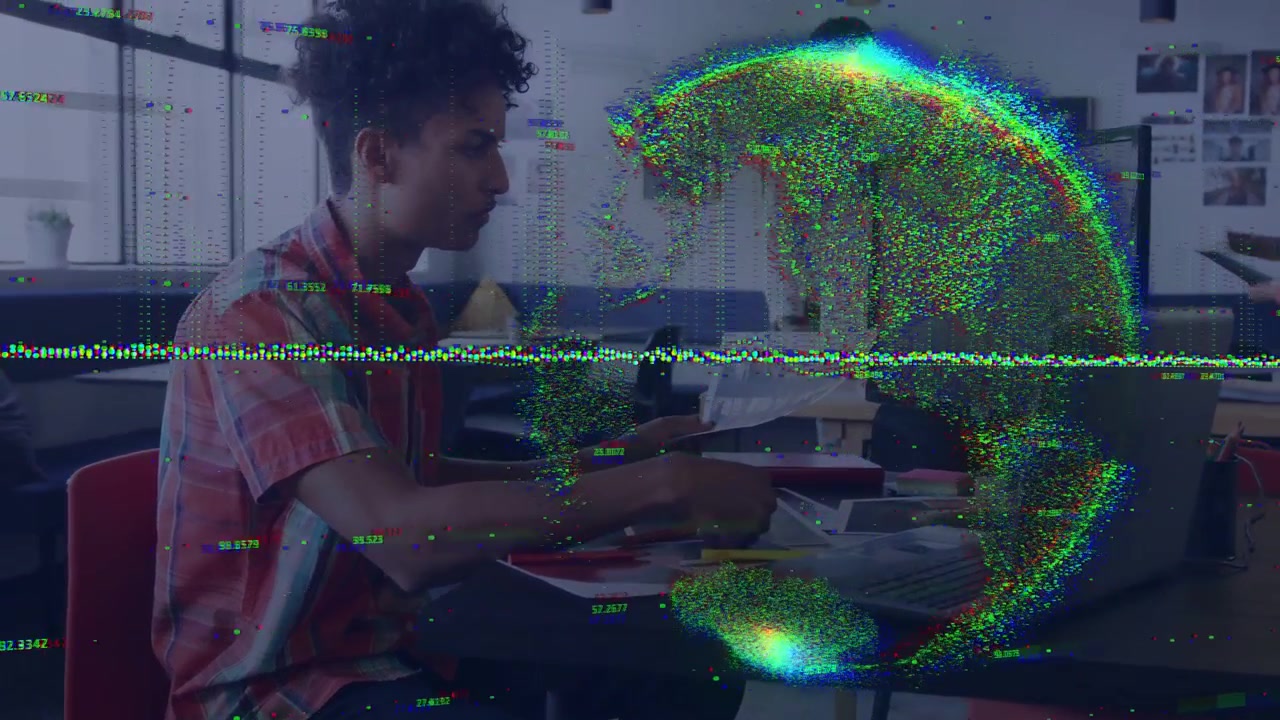 Seated man handling docs, studying while particle globe arising over screen, obscuring, receding
