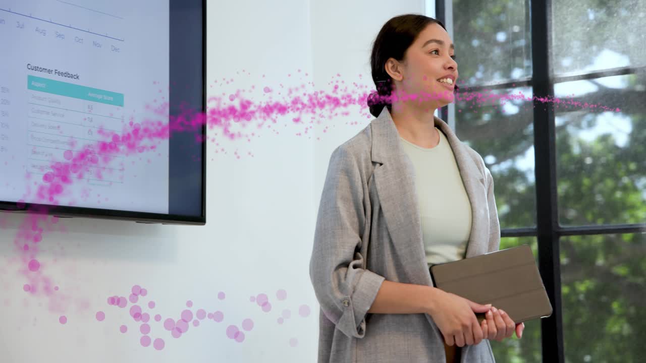 Seated man raising arm, sending pink trail across office curving around presenter showing feedback